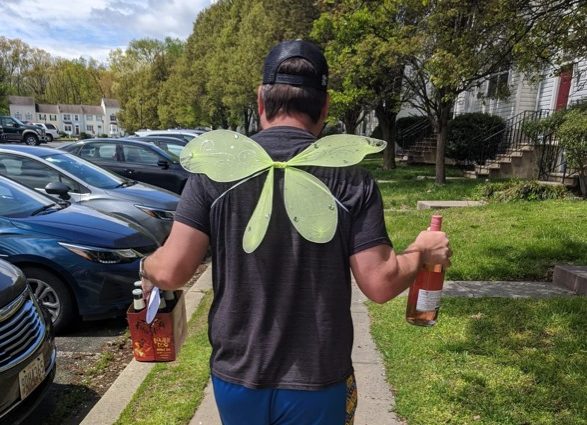 SURVICE employee, Rob, as wine fairy, delivering wine to those who cannot venture out
