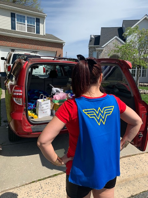 SURVICE employee, Erin, as Wonder Woman, delivering wine gift bags to those who cannot venture out