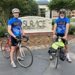 Tim Farm and Dick Schwanke in front of the SURVICE sign