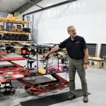 Mark Butkiewicz pointing to parts on a TRV-150.