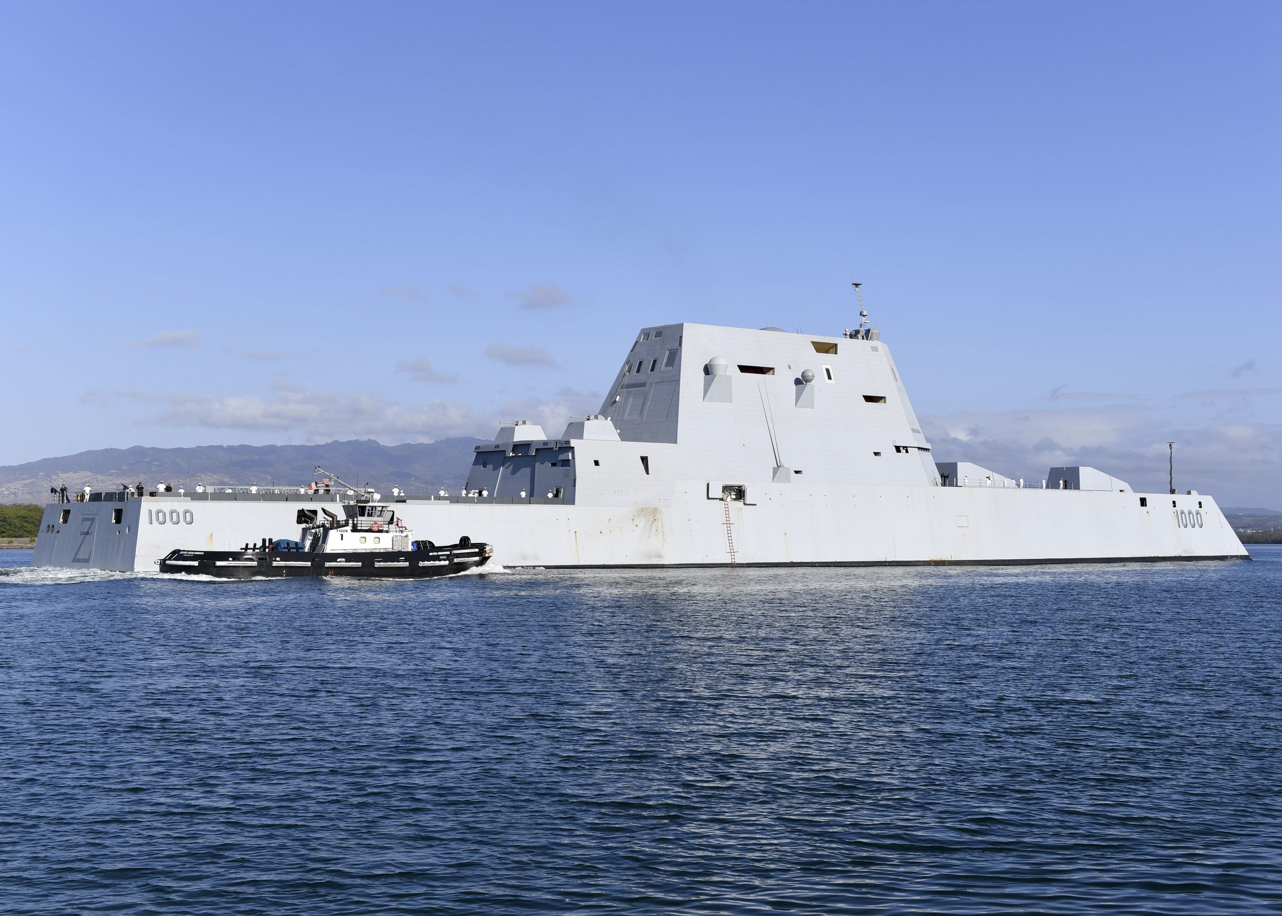190402-N-KR702-1029 PEARL HARBOR (April 2, 2019) Sailors man the rails aboard the guided-missile destroyer USS Zumwalt (DDG 1000) as the ship pulls into Joint Base Pearl Harbor-Hickam. Zumwalt-class destroyers provide the Navy with agile military advantages at sea and with ground forces ashore. (U.S. Navy Photo by Mass Communication Specialist 1st Class Holly L. Herline)