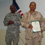 Kelvin participating in his sister's promotion ceremony after they served in Iraq together.